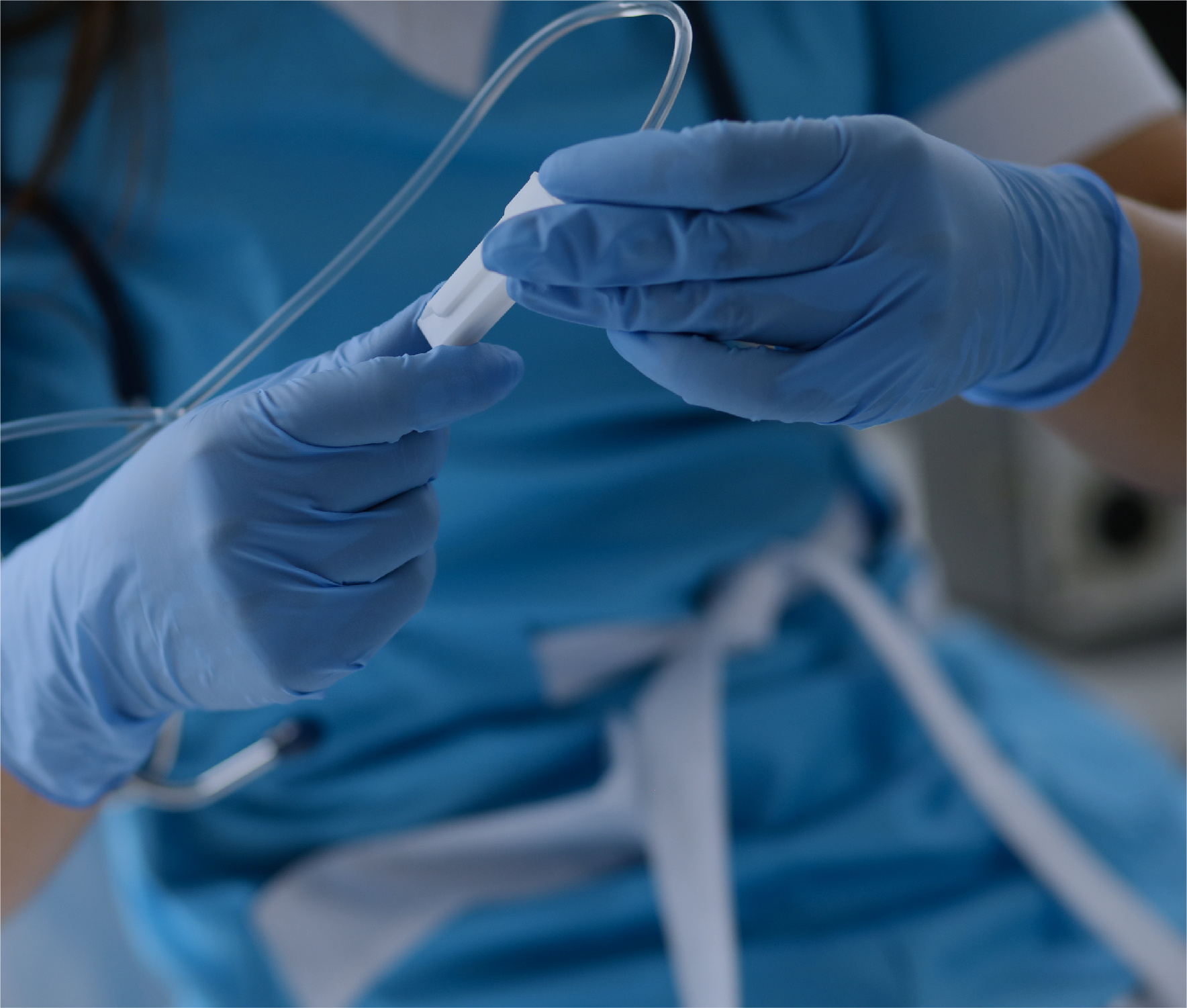 Nurse hands in blue protective gloves holding dropper
