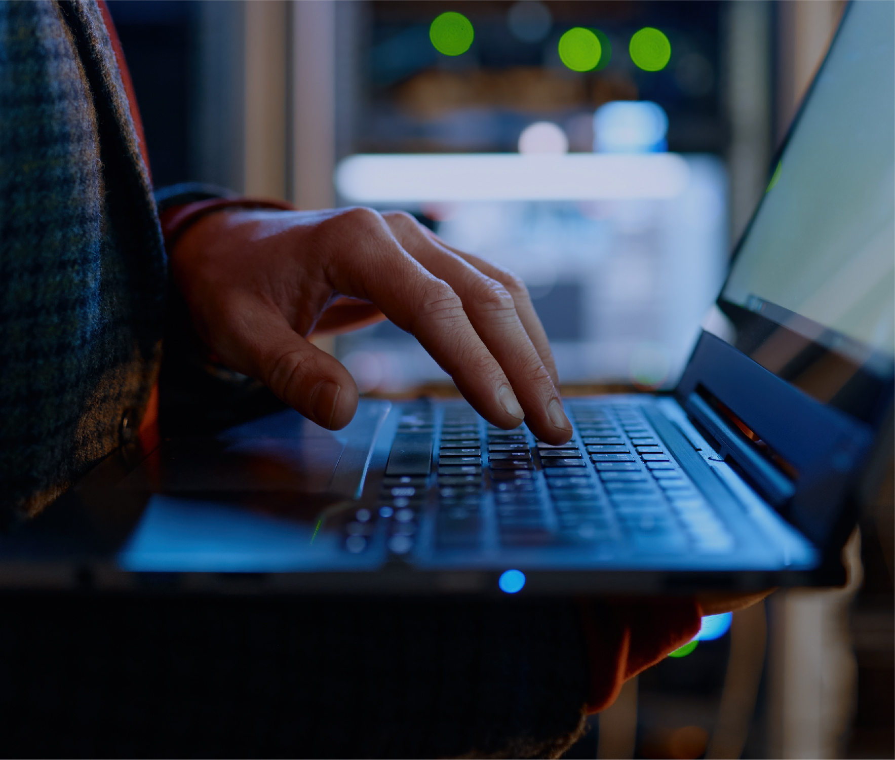 Mans hand typing on laptop keyboard