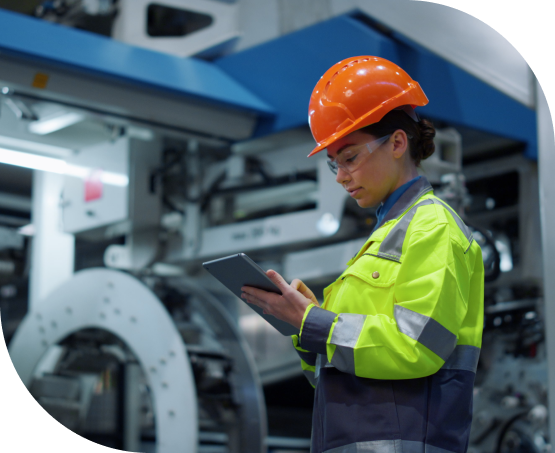 Female manufacturing worker using a tablet in a factory