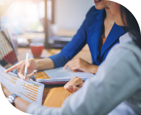 Two professional women reviewing data report together